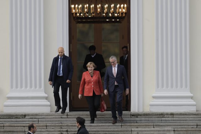 German Chancellor Angela Merkel, centre, leaves Bellevue Palace after a meeting with German President Frank-Walter Steinmeier