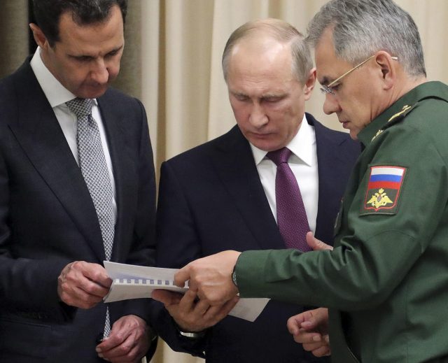 Russian President Vladimir Putin, center, and Syrian President Bashar Assad, left, and Russian Defense Minister Sergei Shoigu 