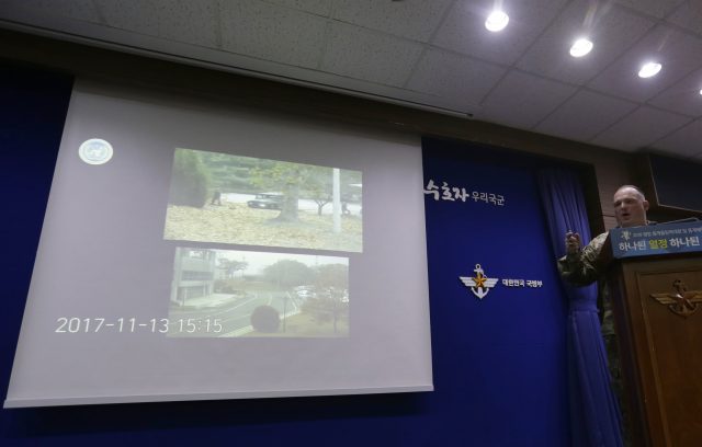 Colonel Chad G Carroll, a spokesman for the UN command, shows the CCTV footage depicting the North Korean soldier's defection during a press conference at the Defence Ministry in Seoul