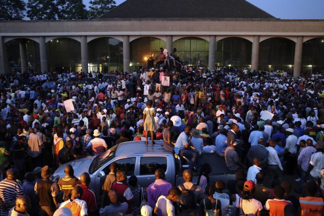 Supporters of Emmerson Mnangagwa wait for his arrival at the Zanu PF Headquarters in Harare  (AP Photo/Tsvangirayi Mukwazhi)