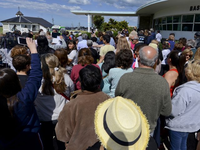 People hold a vigil for those missing outside the navy base in Mar del Plata, Argentina 