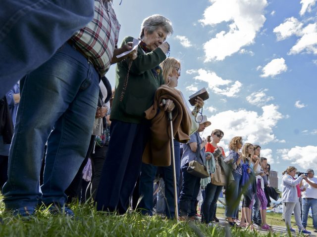 People pray for the missing crew