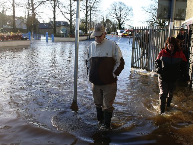 People walk through flood water in Mountmellick, Co Laois 