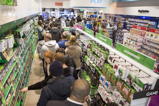 Shoppers queue to buy gaming merchandise in games retailer GAME in Westfield shopping centre in Stratford during a Black Friday event
