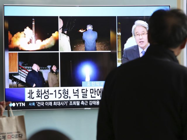 Commuters watch news reports on the latest launch in Seoul 