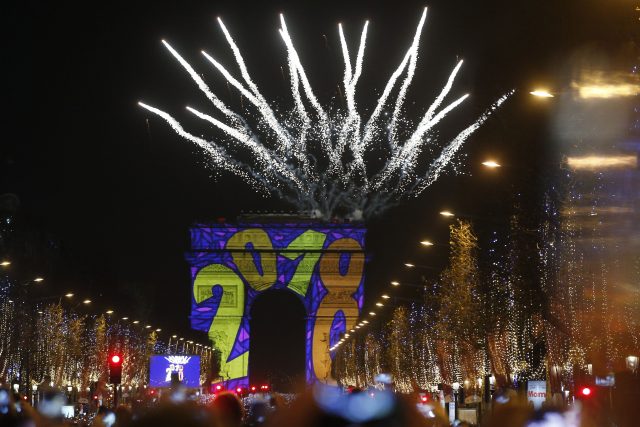 Fireworks explode over the Arc de Triomphe in Paris (Thibault Camus/AP)