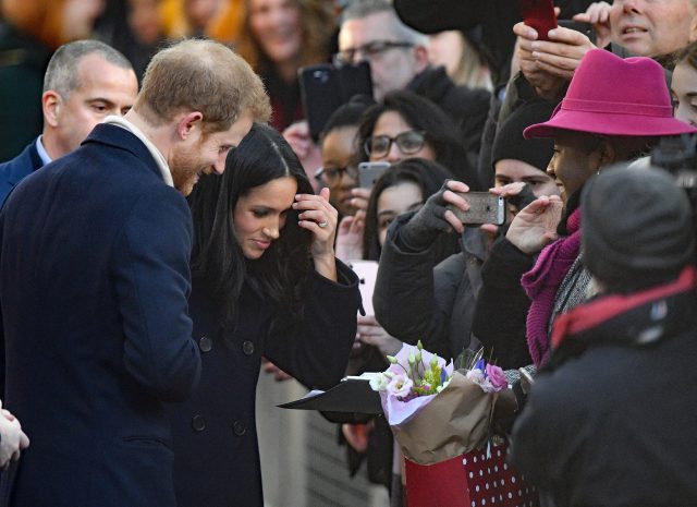 Ms Markle was given flowers by well-wishers (Victoria Jones/PA)