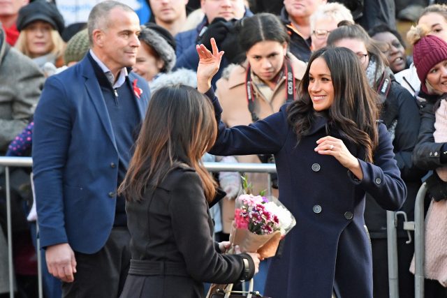 Prince Harry and Ms Markle split up to chat with people lining both sides of the route (Victoria Jones/PA)