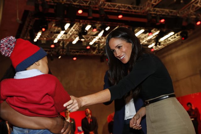 Meghan Markle meets a child at the Terrence Higgins Trust World AIDS Day charity fair (Adrian Dennis/PA)