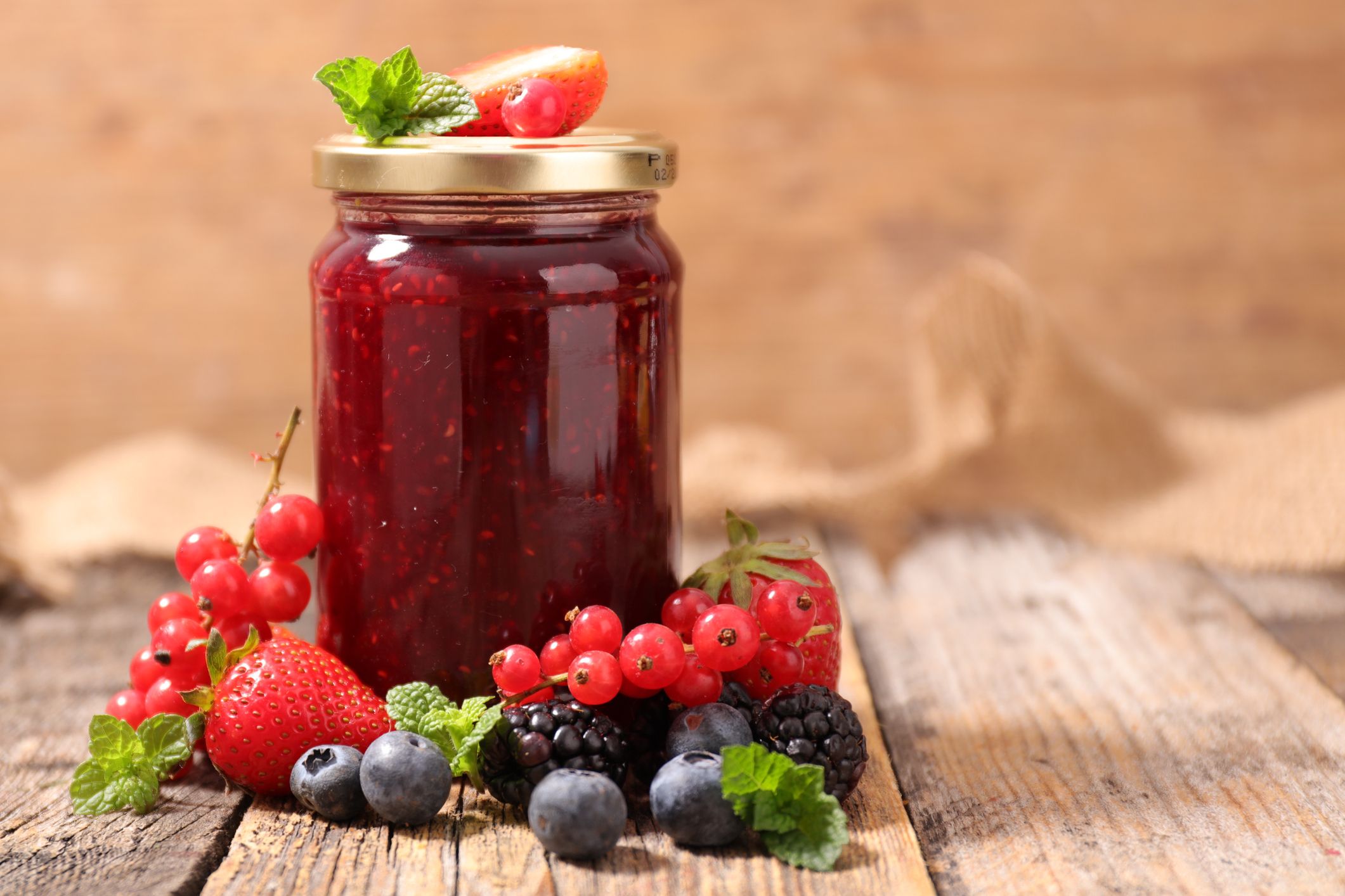 Jam jar with berry fruits