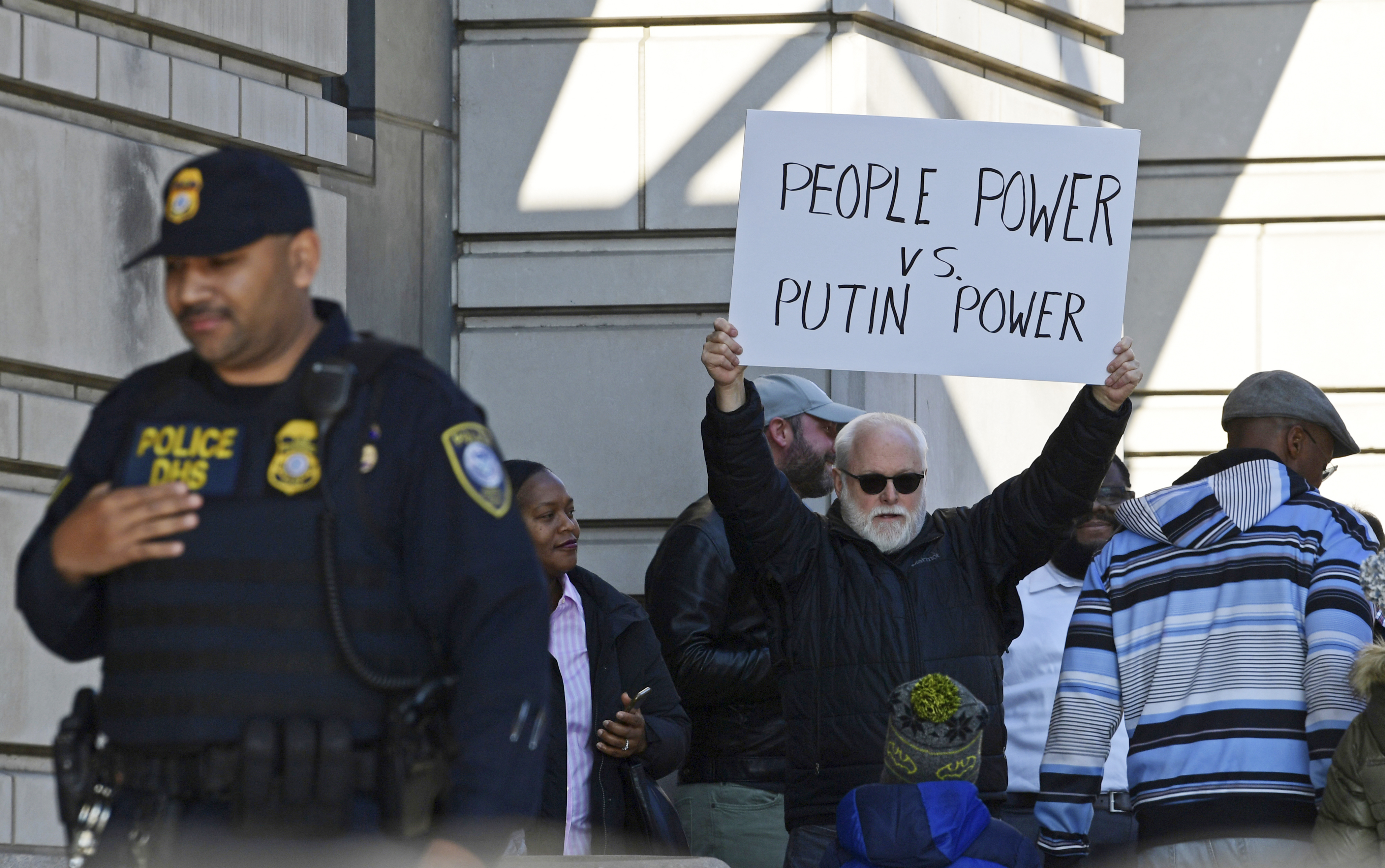 A protestor stands outside federal court in Washington