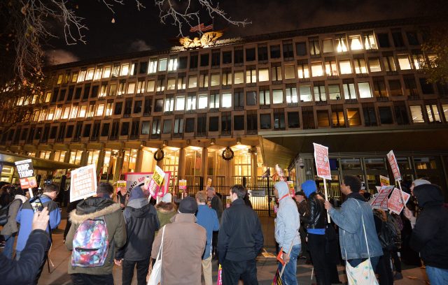 People take part in a protest organised by Stand Up To Racism outside the US Embassy in London