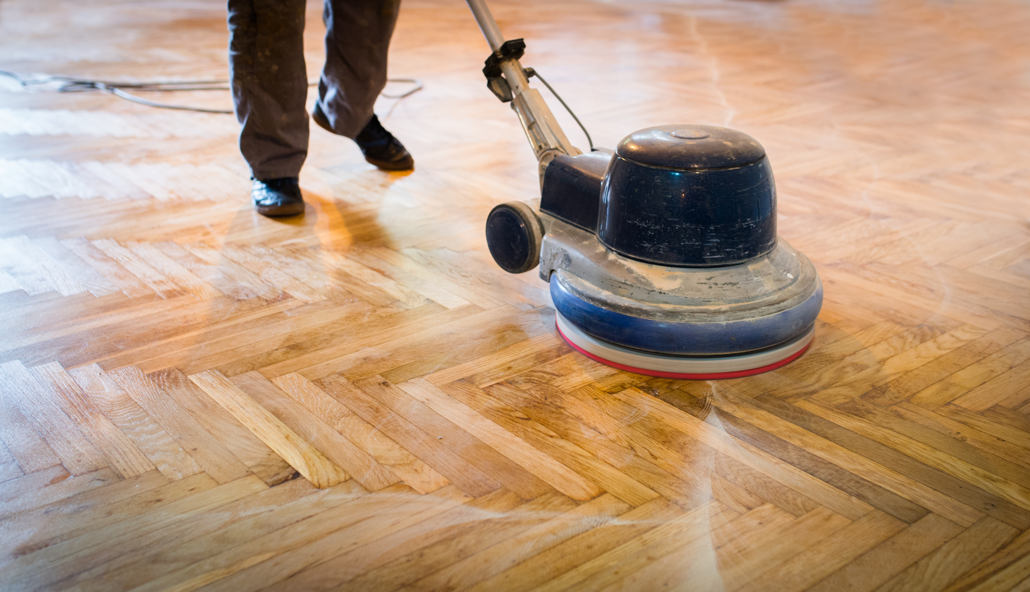 Someone sanding a floor