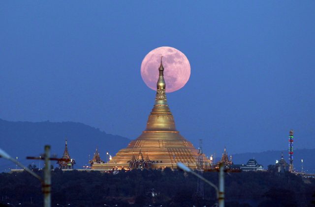 The moon rises behind the Uppatasanti Pagoda seen from Naypyitaw in Burma (Aung Shine Oo/AP)