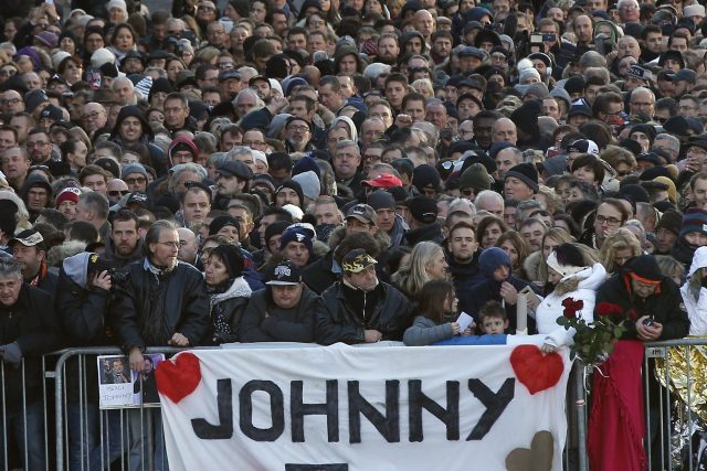 Fans wait outside the Madeleine church for Johnny Hallyday's funeral ceremony. (Thibault Camus/AP)