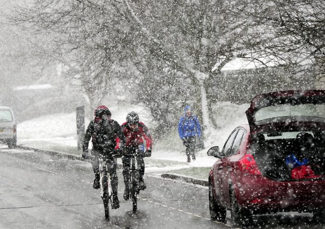 Cyclists braving the elements. (John Giles/PA)