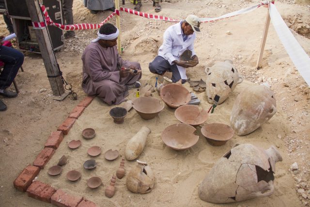Egyptian excavation workers restore pottery near a new found tomb in Draa Abul Naga necropolis. (Hamada Elrasam/AP)