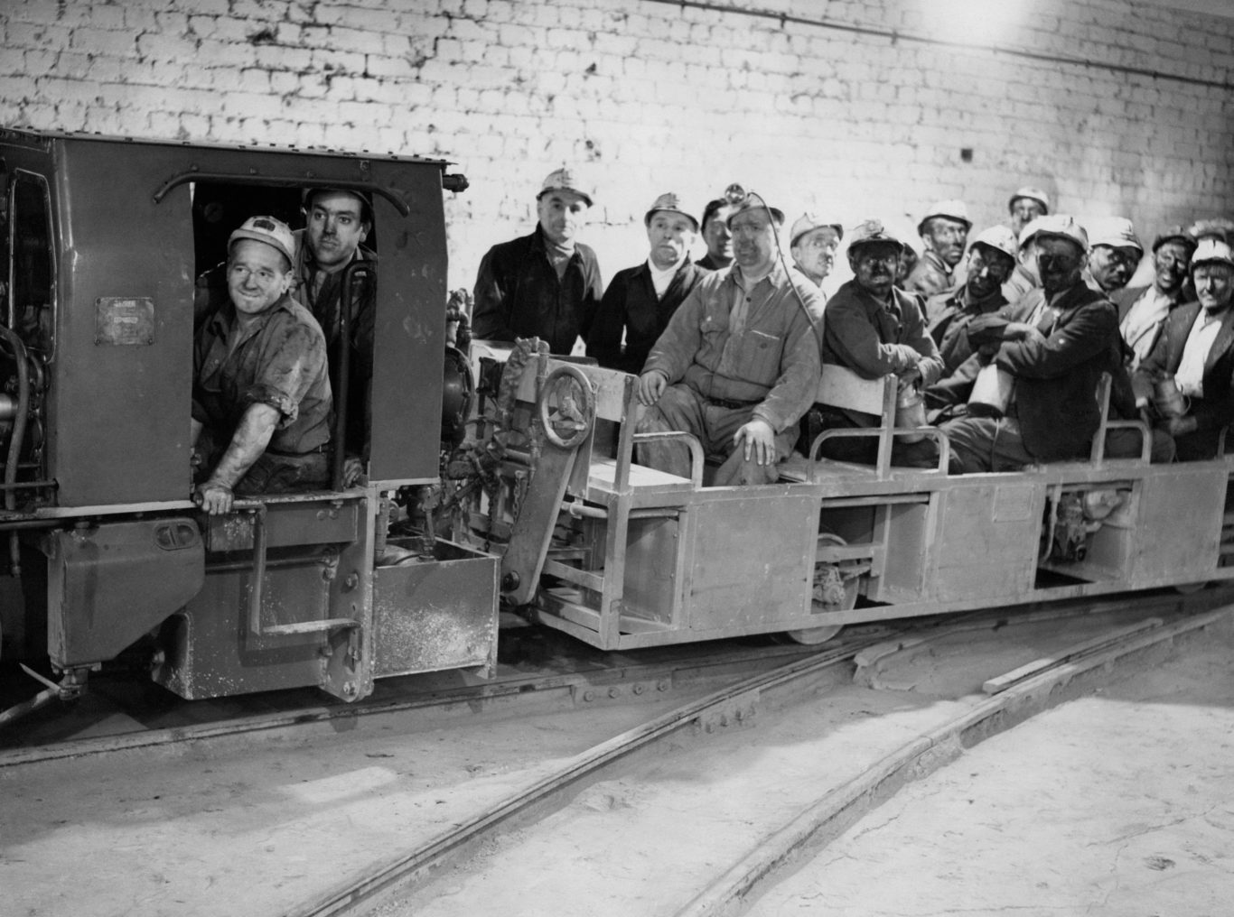 Miners coming off shift by way of the newly-installed diesel railway at Nook Colliery, Astley, Lancashire, 1948 (PA)