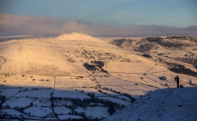 A photographer takes a picture near Mam Tor in Derbyshire's Peak District (Peter Byrne/PA)