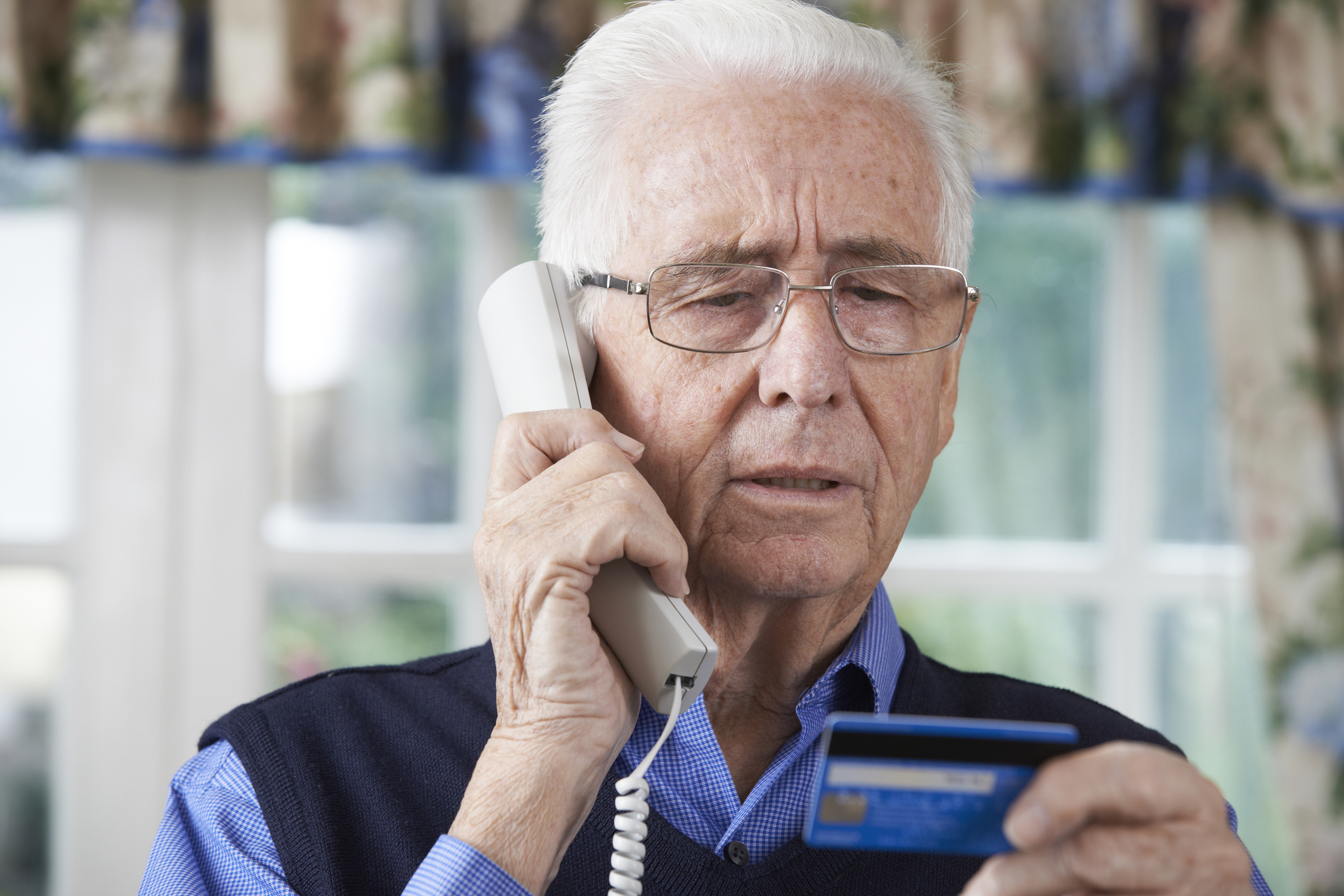 Generic photo of an elderly man giving out his bank details on the phone (Thinkstock/PA)