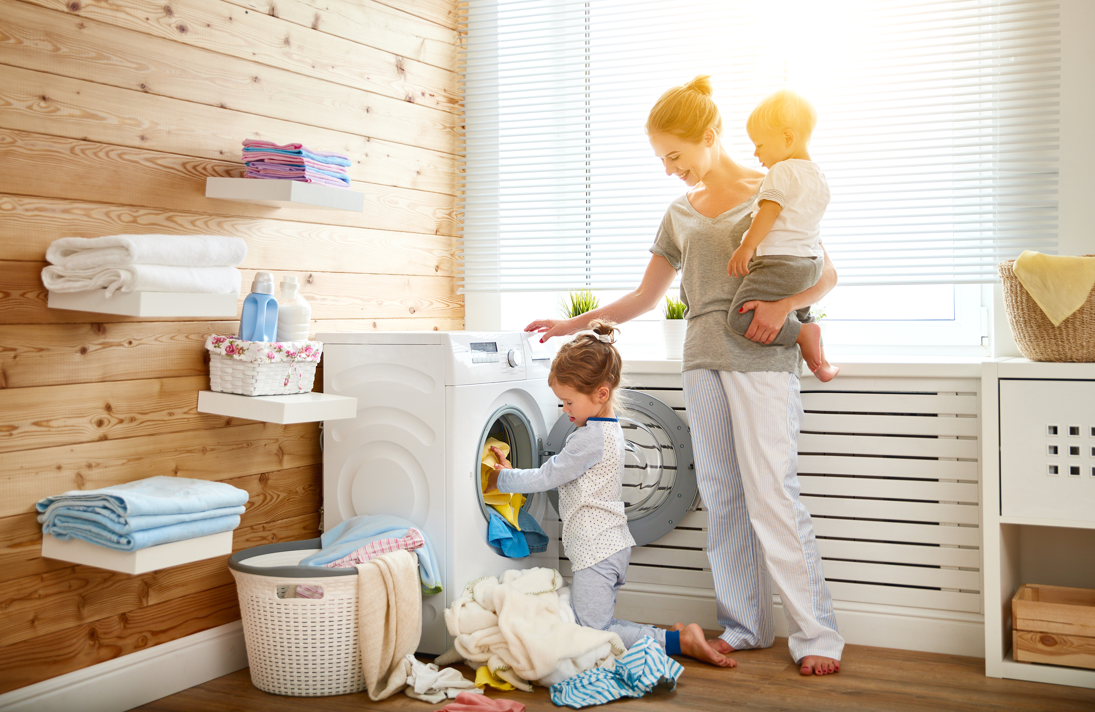 Generic photo of a woman and two young children doing laundry (Thinkstock/PA)