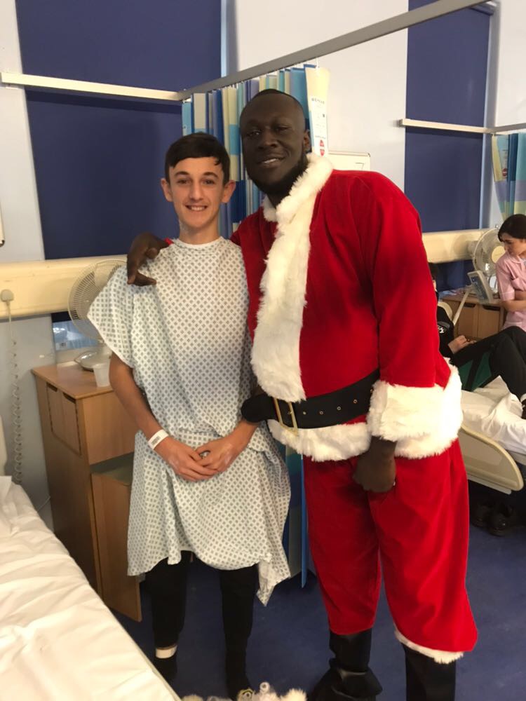 Stormzy with a young patient (Barts Health/PA)