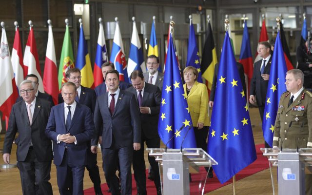 European Council President Donald Tusk, front centre, and European Commission President Jean-Claude Juncker, front left, lead EU leaders to a group photo at an EU summit at the Europa building in Brussels (Olivier Matthys/AP)