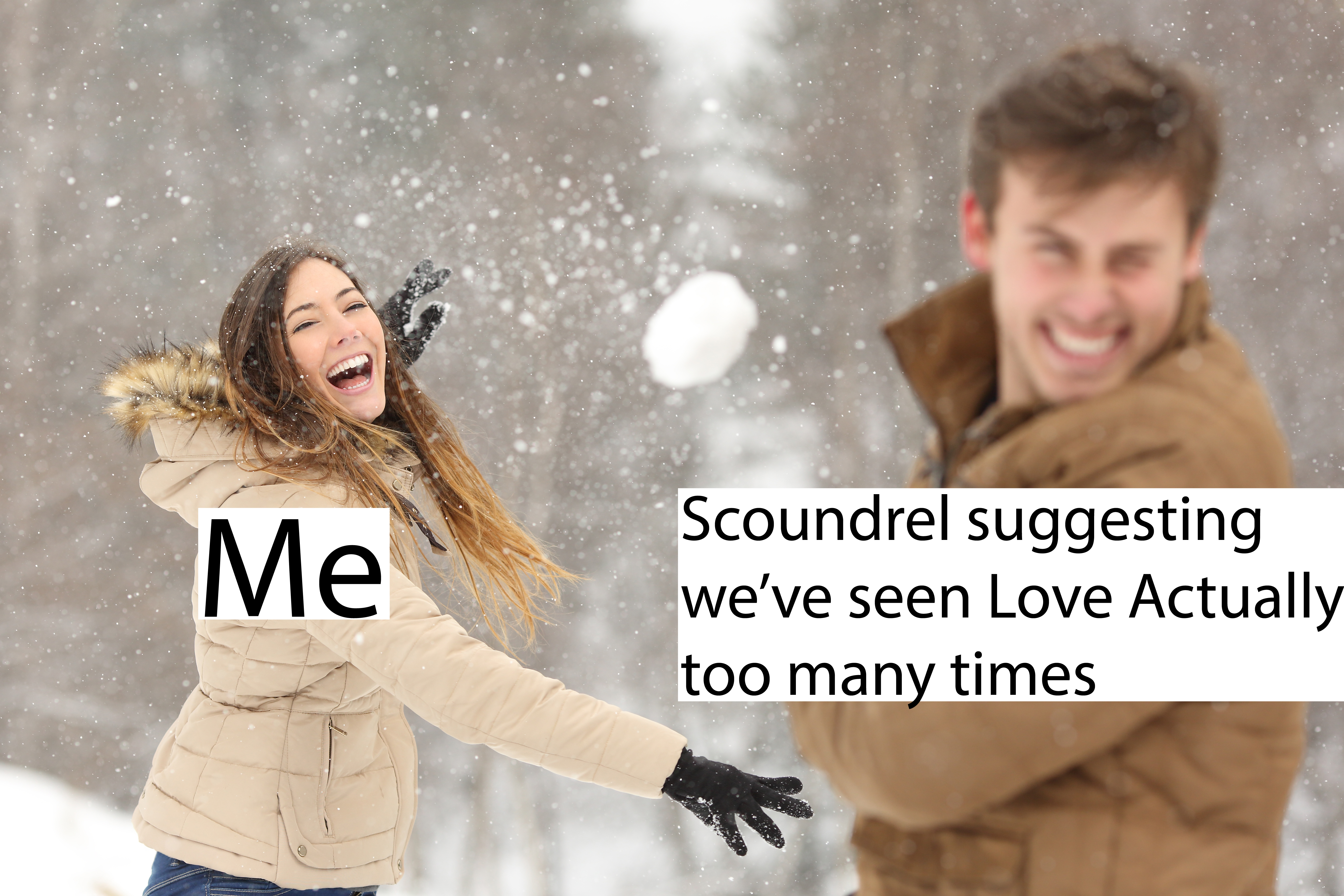 Couple playing with snow and girlfriend throwing a ball in winter holidays