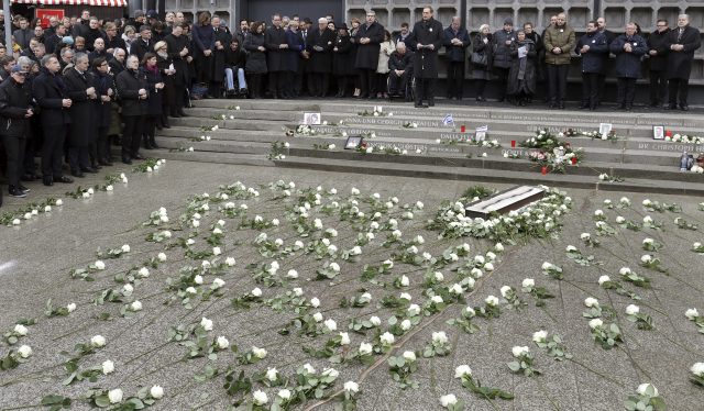 People attend the opening of a memorial site in Berlin to honour the victims of the Christmas market attack one year ago. (Michael Sohn/AP/PA)
