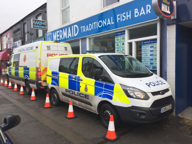Police vans parked up outside a fish and chip shop in Chesterfield (Josh Payne/PA)