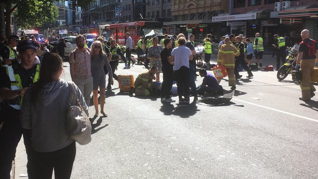 Paramedics treat a victim after a car ploughed into pedestrians in Melbourne, Australia (Andrew Lund/Twitter)