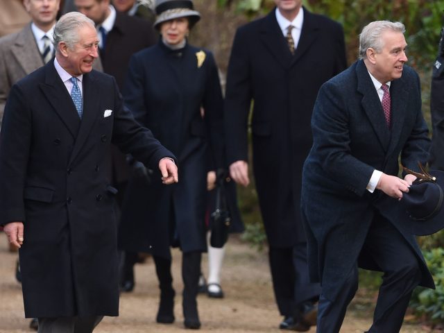 The Prince of Wales laughs as the Duke of York catches a blown-away hat