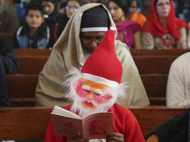 A boy dressed as Santa during a service in Jammu