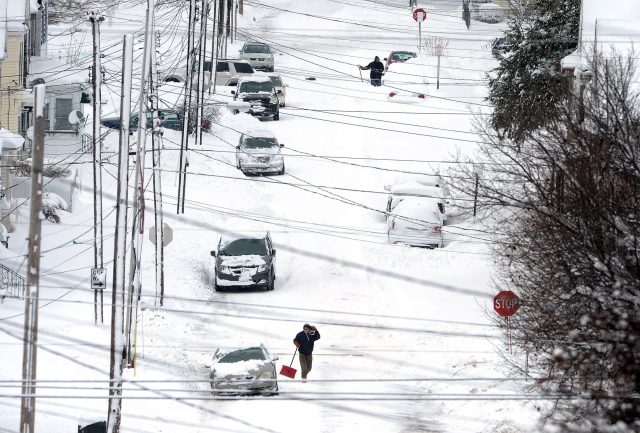 Erie residents shovel snow on East 24th Street after a record two-day snow fall (Greg Wohlford/Erie Times-<a href=
