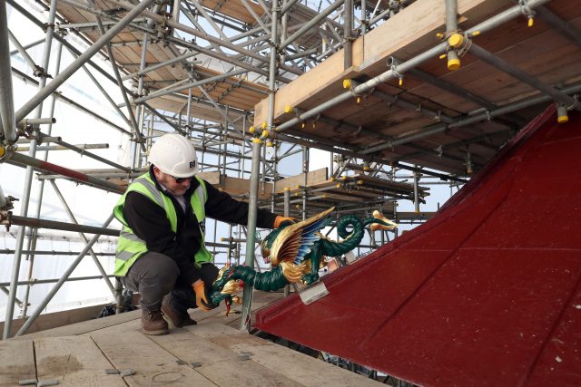A workman at roof level with one of the 80 dragons that are being replaced on the 163ft tall Great Pagoda (Steve Parsons?PA)