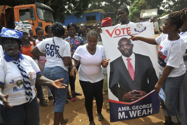 Supporters of George Weah celebrate in Monrovia (Abbas Dulleh/AP)