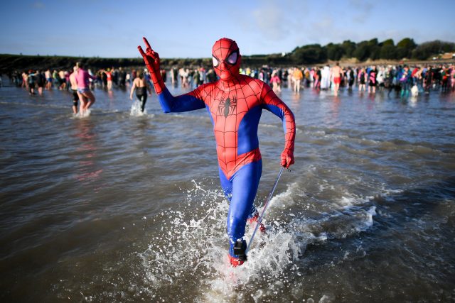 Spider senses tingling... Spiderman runs into in the sea at Barry Island (Ben  Birchall/PA)