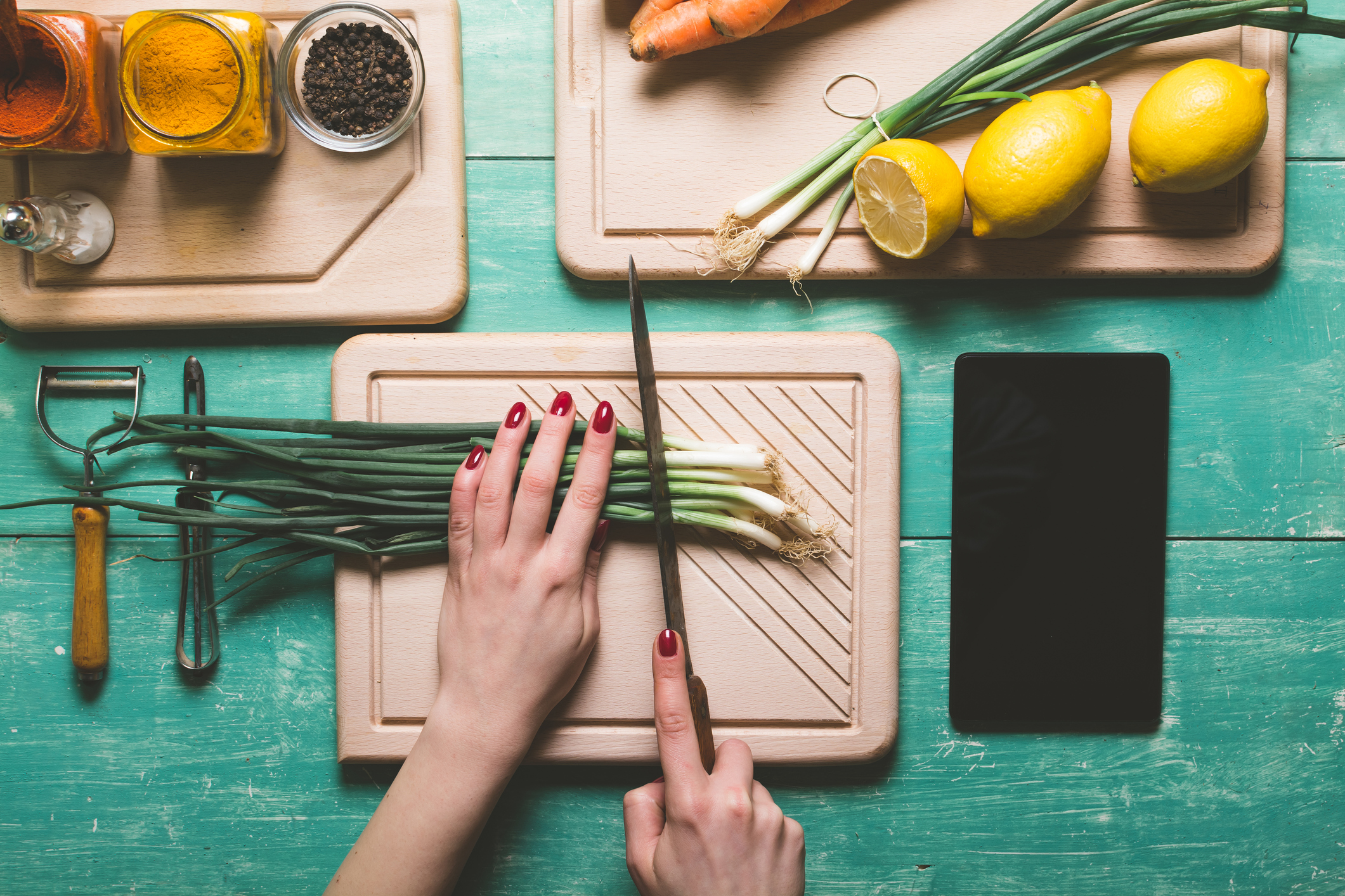 Generic image showing woman's hands cutting fresh spring onion on a blue wooden table (Thinkstock/PA)