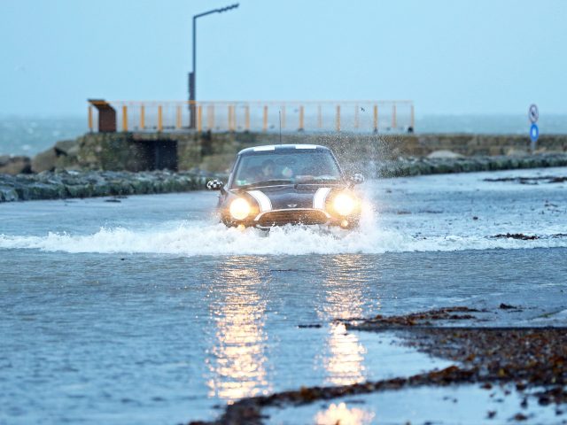 A car drives through a flooded car park in Salthill, Galway 