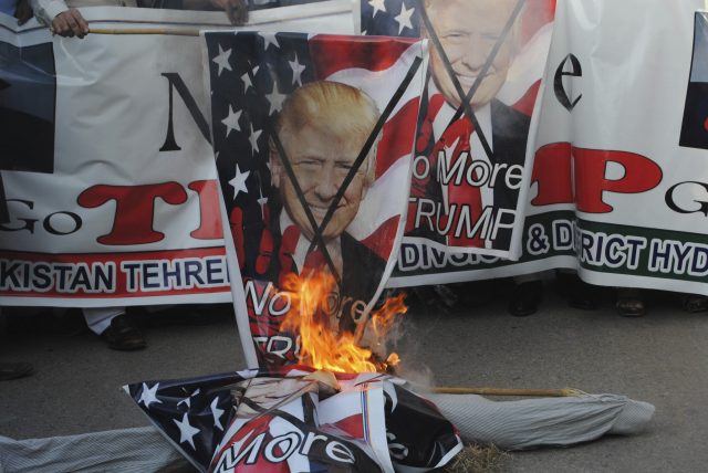 Pakistani protesters burn banners showing Donald Trump