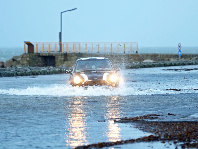 A car drives through a flooded car park in Salthill, Galway