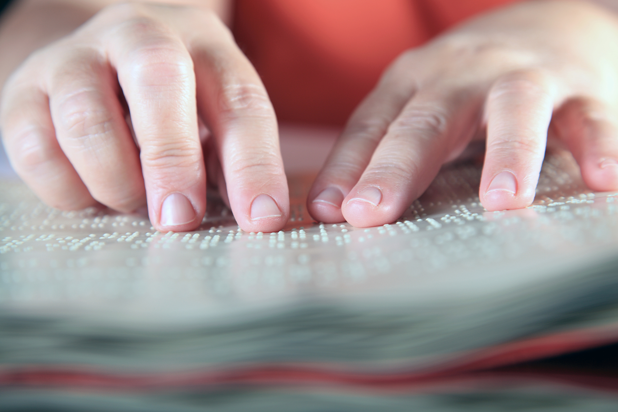 Person reading Braille (portokalis/Getty Images)