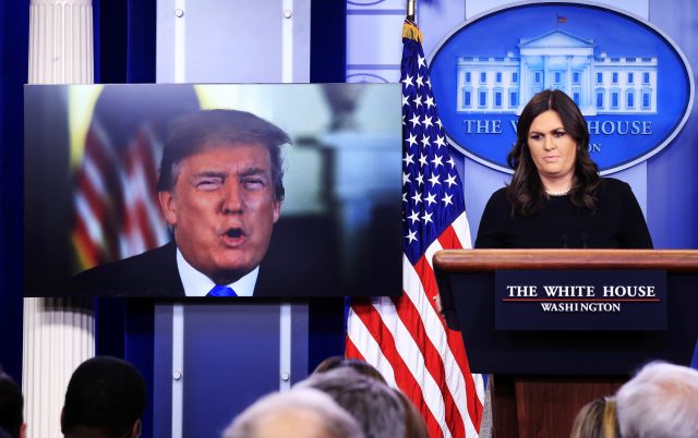 Mr Trump speaks via a video monitor to journalists in a daily press briefing with Sarah Huckabee Sanders (Manuel Balce Ceneta/AP)