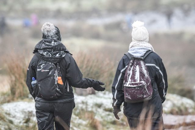 More casual walkers were also seen carrying snow-covered rucksacks (Ben Birchall/PA)