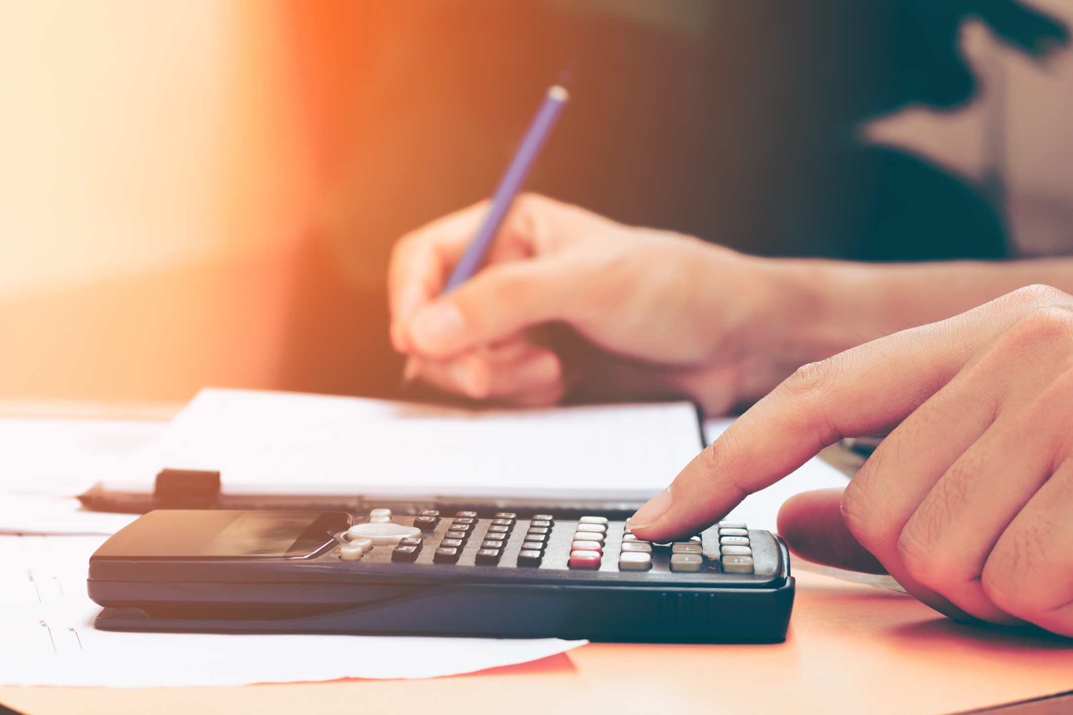 Close up young woman with calculator counting making notes at home (Thinkstock/PA)