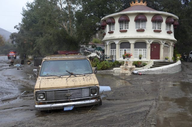 Mud flows leave a van stuck in the mud along La Tuna Canyon road in the Sun Valley neighbourhood of Los Angeles (David Crane/Los Angeles Daily News via AP)
