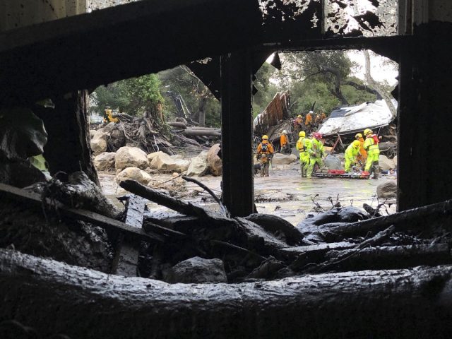 Firefighters respond to mud and debris flow due to heavy rain in Montecito. California (Mike Eliason/Santa Barbara County Fire Department via AP)