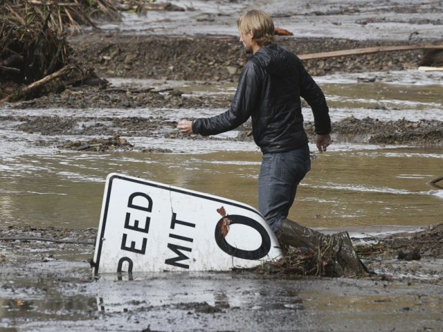 A man wades through mud in Montecito 