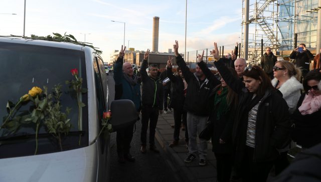 Members of the Kurdish community pay their respects as the coffins of British men Jac Holmes and Ollie Hall leave Heathrow Airport (Steve Parsons/PA)
