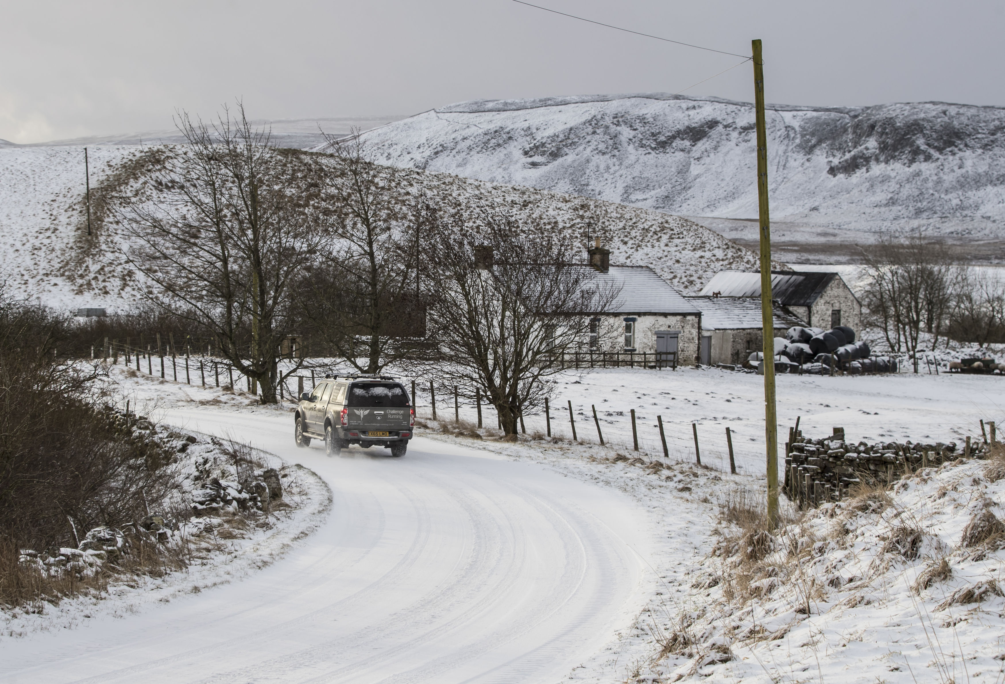 A car navigates a snowy road in Langdon Beck as the area in the North Pennines was blanketed by snow overnight (Danny Lawson/PA)